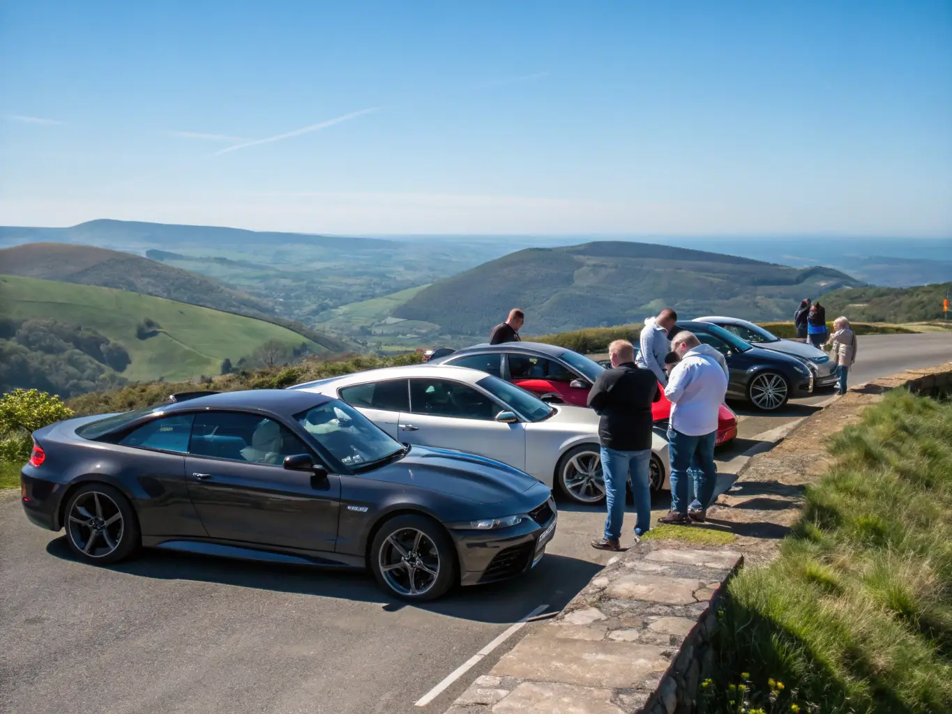 A group of members gathered at a community event, showcasing classic cars and engaging in friendly conversation and knowledge sharing.